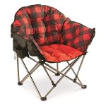 Oversized camping chair with cup holder and mesh pocket, shown folded and open at a campsite.