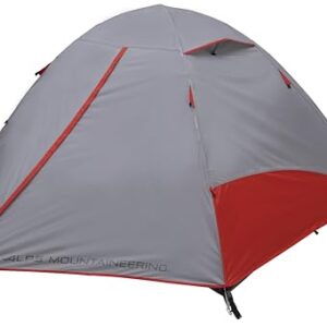 ALPS Mountaineering Taurus 2-Person Tent set up in a natural outdoor setting, showcasing its gray and red color scheme, spacious interior with mesh roof, and two vestibules.