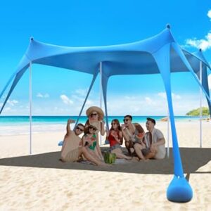 Osoeri Beach Tent set up on the sand, featuring a large 10×10 ft shaded area, with sandbags, stability poles, and ground pegs, designed for sun protection and stability during outdoor activities