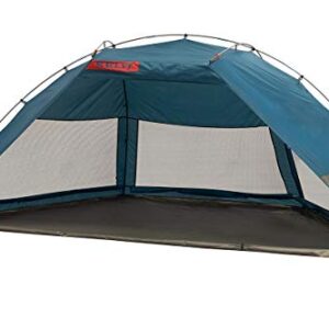 Kelty Cabana Shade Tent set up on a sandy beach, showcasing its spacious interior, mesh windows for ventilation, and durable polyester material, with the duffel-style carry bag visible.